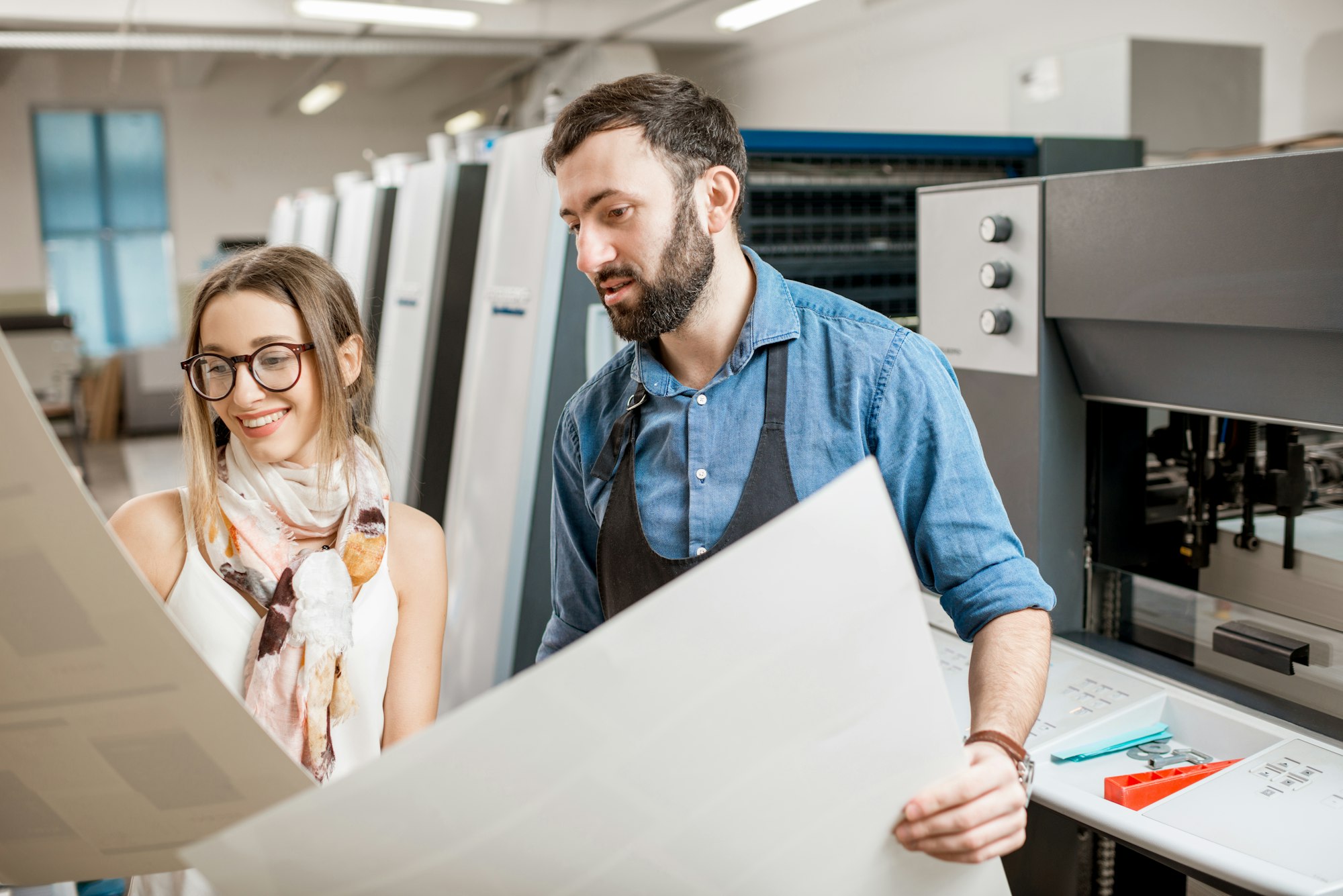 Woman with print operator at the printing manufacturing